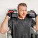 Beginner gym mistakes man struggling with weightlifting form in a gym scaled